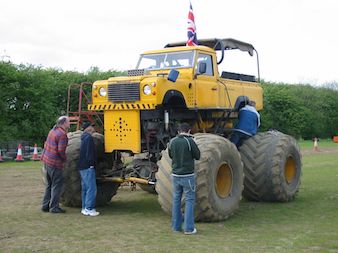 An audio crew confronts a monster truck on a recording session